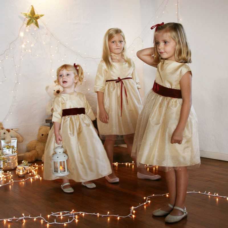 Elena gold and burgundy velvet christmas party dress for little girls by French UK designer Little Eglantine smiling