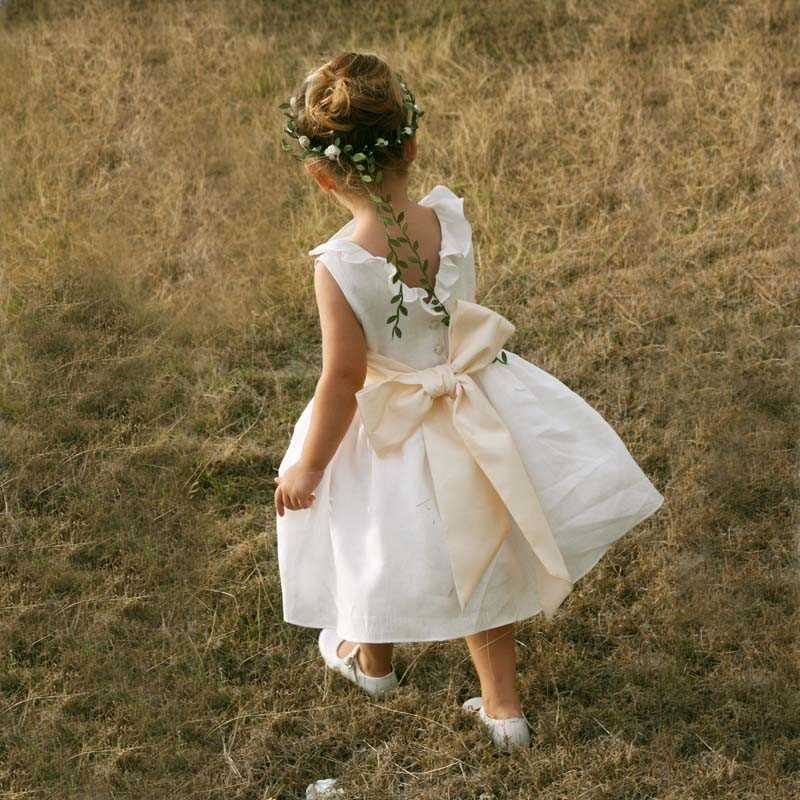 Erica linen flower girl dress with ruffled V neck by French designer Little Eglantine