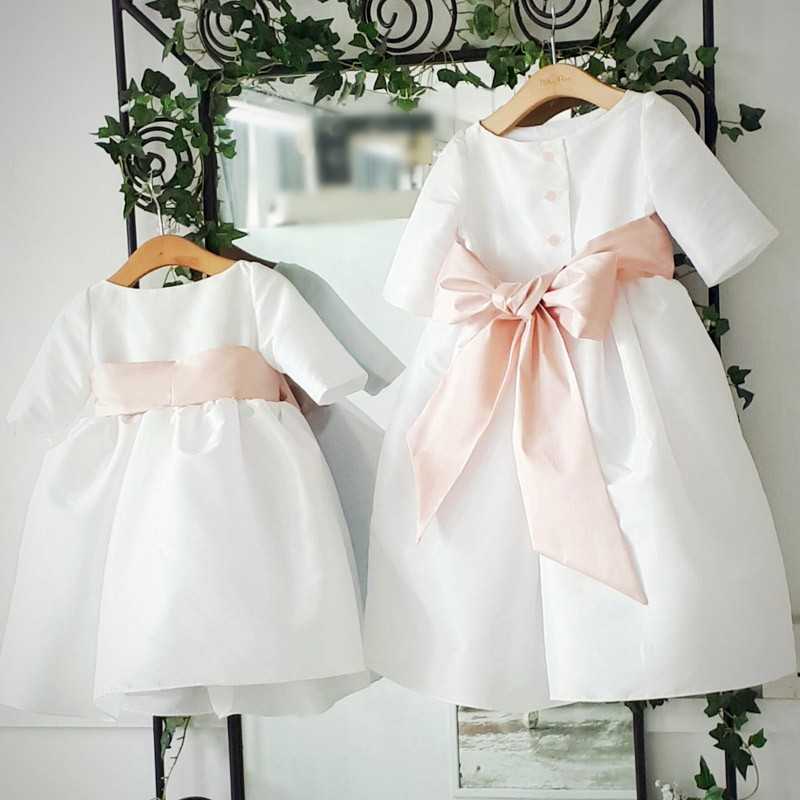 Claire 3/4 length sleeves white flower girl dress with powder pink sash by French designer Little Eglantine