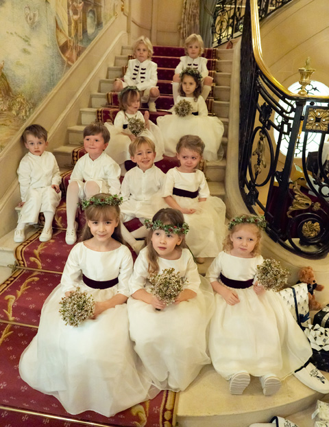 White and burgundy flower girl dresses and page boy outfits for a Christmas wedding in London by Little Eglantine
